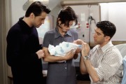 Medium shot standing in hospital room, of Matt LeBlanc as Joey, Courteney Cox as Monica holding baby and David Schwimmer as Ross, touching baby's head. (Episode #456672)