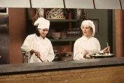 Medium shot of Courteney Cox as Monica and Clea Lewis as Franny, both wearing chef uniforms in restaurant kitchen. (Episode #475085)