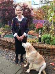 Sr. Stan with her dog in Sanctuary garden - Being Stan: A Life in Focus