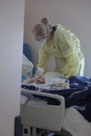 RTE Investigates - Inside Ireland's Covid Battle - Student Nurse tends to a patient